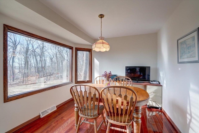 dining space featuring hardwood / wood-style floors and a healthy amount of sunlight