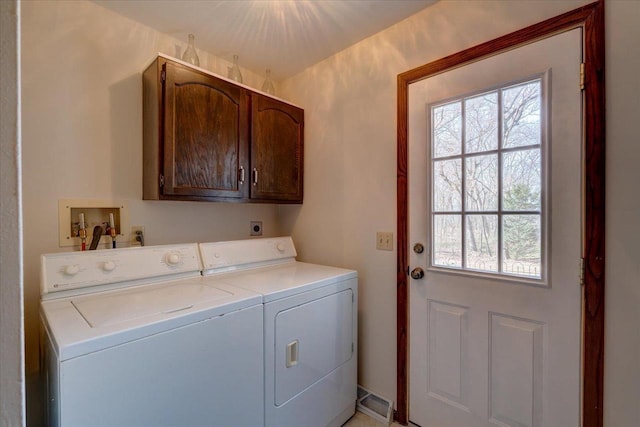 laundry area with cabinets and washing machine and dryer