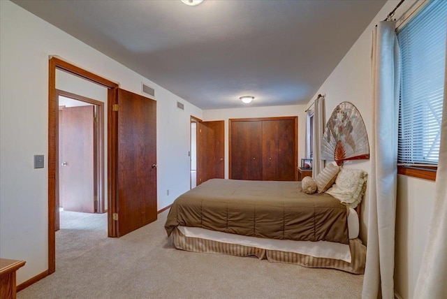 bedroom featuring light colored carpet