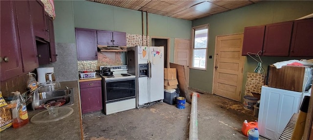 kitchen with sink, white appliances, concrete flooring, and decorative backsplash