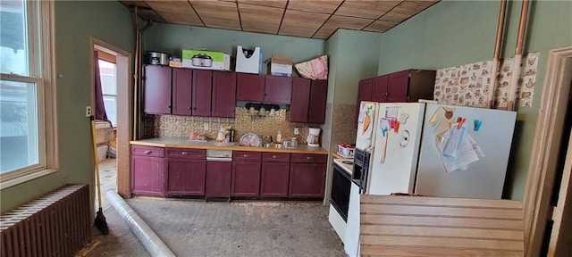 kitchen with radiator, wooden ceiling, white fridge with ice dispenser, a healthy amount of sunlight, and decorative backsplash