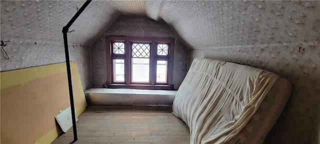 bonus room featuring vaulted ceiling and light hardwood / wood-style flooring