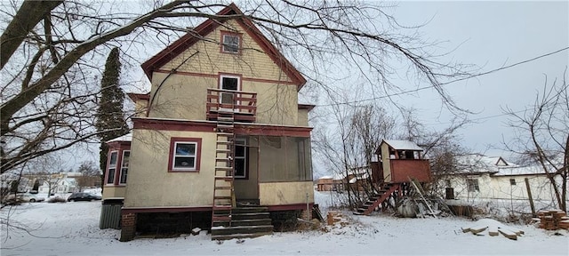 view of snow covered rear of property