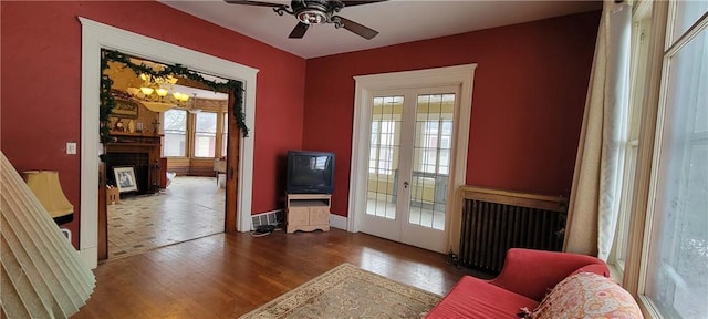 doorway with ceiling fan, french doors, radiator, and dark hardwood / wood-style floors