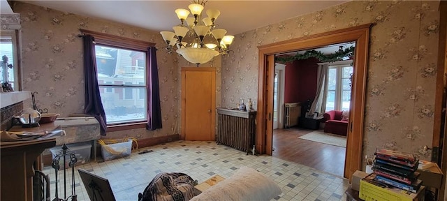 interior space featuring light hardwood / wood-style floors, plenty of natural light, and a notable chandelier