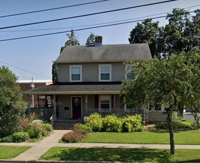 242 W Hickory St, Lancaster, WI 53813 - view of front of home with a front lawn, a porch, and a chimney