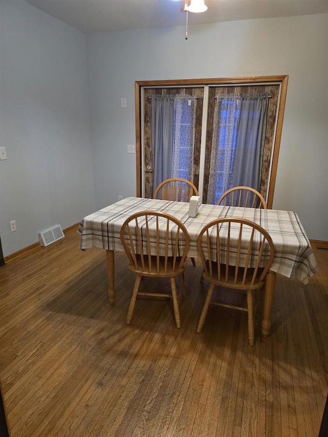 dining room with ceiling fan and wood-type flooring