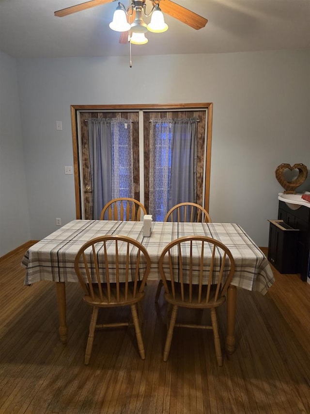 dining space with hardwood / wood-style flooring and ceiling fan