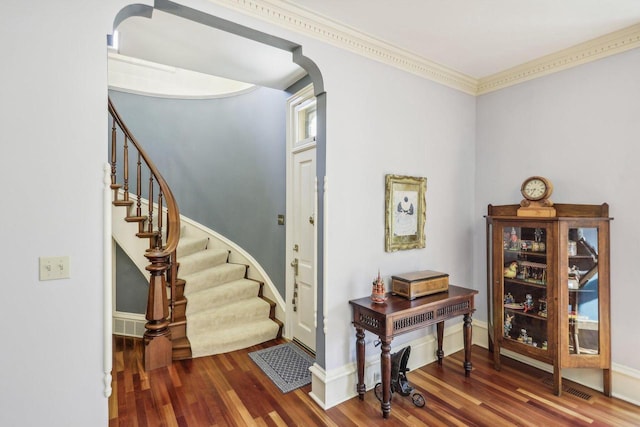 entrance foyer featuring crown molding and hardwood / wood-style flooring