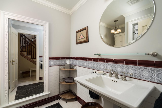 bathroom featuring tile patterned floors, tile walls, sink, a notable chandelier, and ornamental molding