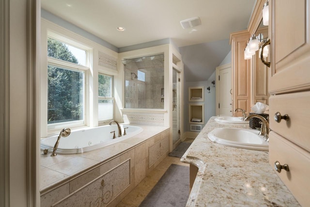 bathroom with vanity, tile patterned floors, and plus walk in shower