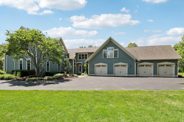 view of front of home with a garage and a front lawn