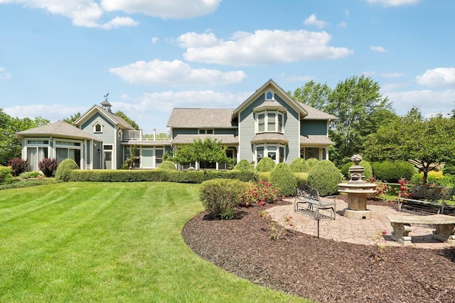 back of house featuring a patio area and a yard