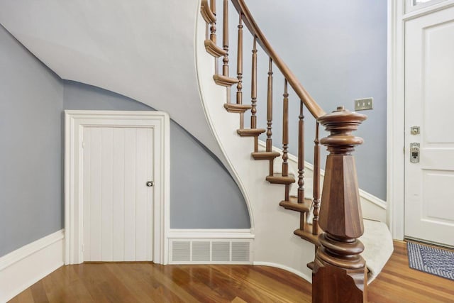 stairs featuring hardwood / wood-style flooring