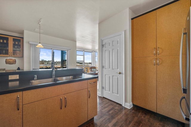 kitchen featuring sink, hanging light fixtures, stainless steel fridge, and dark hardwood / wood-style floors