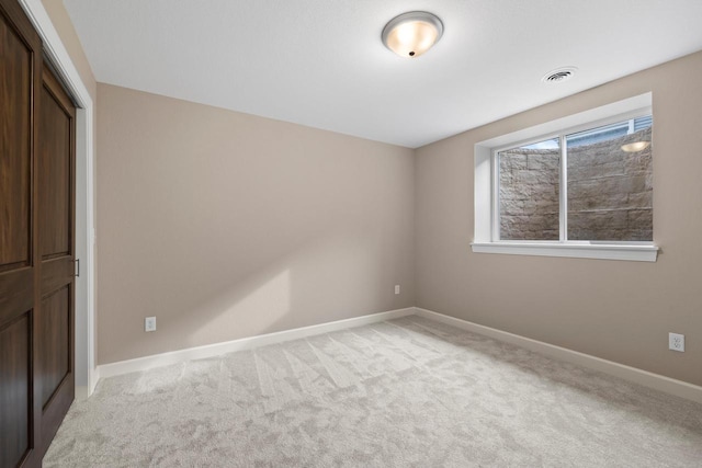 unfurnished bedroom featuring light colored carpet and a closet