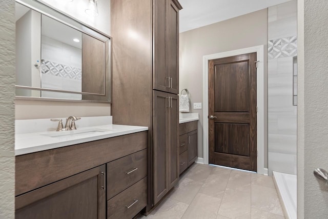 bathroom featuring walk in shower and vanity