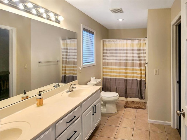 bathroom featuring vanity, curtained shower, tile patterned floors, and toilet