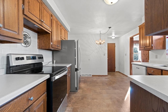 kitchen with white dishwasher, hanging light fixtures, decorative backsplash, electric range, and an inviting chandelier