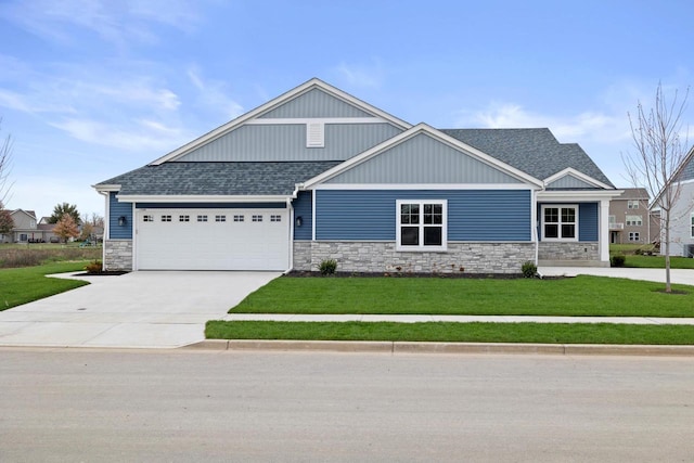 craftsman inspired home featuring a garage and a front yard