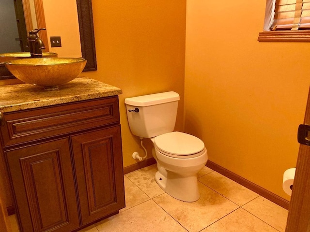 bathroom featuring vanity, tile patterned flooring, and toilet