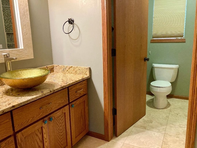 bathroom featuring tile patterned floors, toilet, and vanity