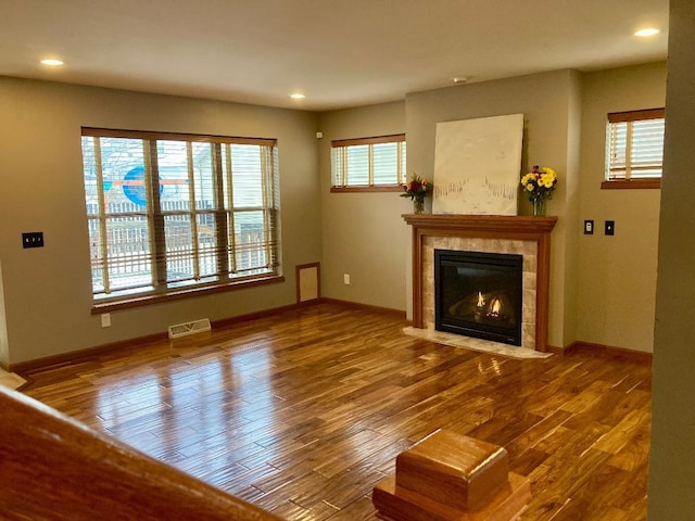 unfurnished living room with hardwood / wood-style flooring and a fireplace