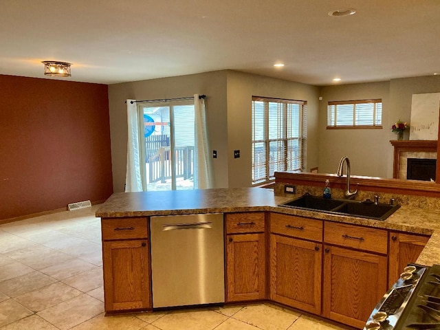 kitchen featuring a healthy amount of sunlight, appliances with stainless steel finishes, sink, and light tile patterned floors