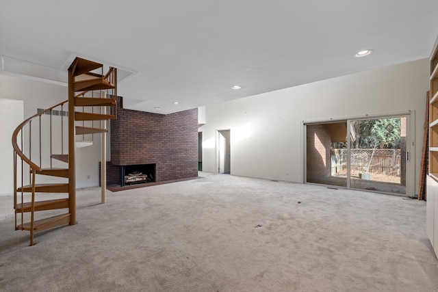 unfurnished living room with light carpet and a brick fireplace