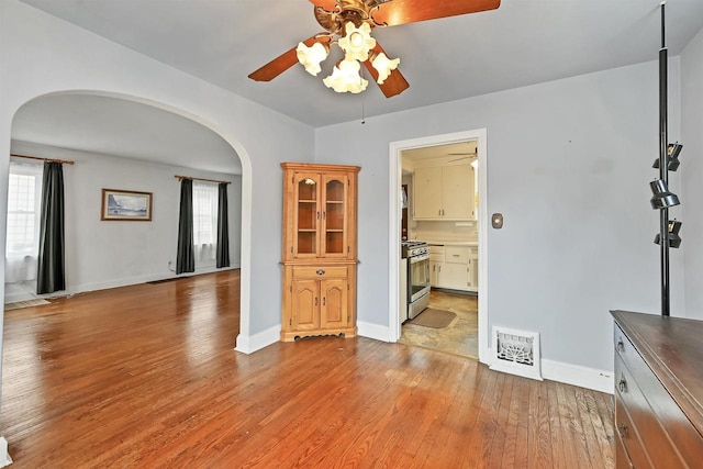 empty room with a healthy amount of sunlight, light hardwood / wood-style flooring, and ceiling fan