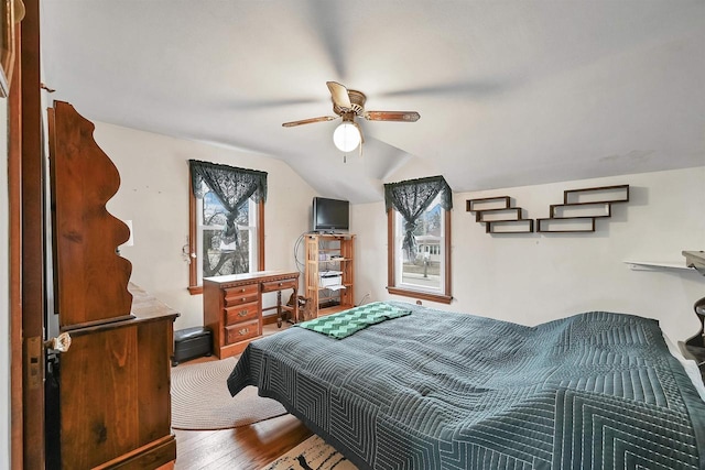 bedroom with lofted ceiling, hardwood / wood-style flooring, and ceiling fan