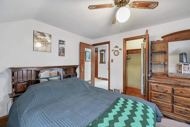 bedroom featuring a closet, ceiling fan, a spacious closet, and lofted ceiling