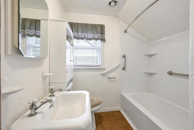 full bathroom featuring sink, shower / tub combination, toilet, and lofted ceiling