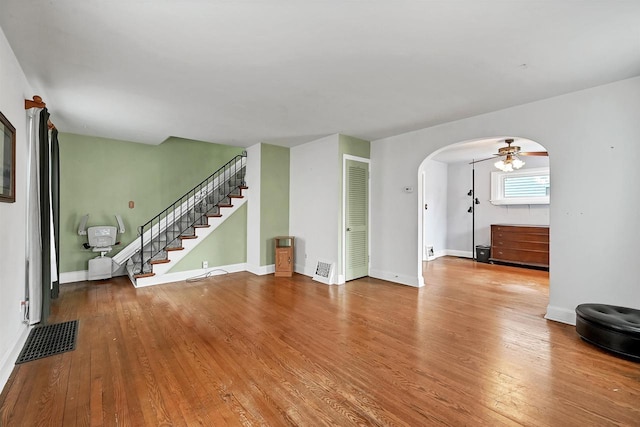 unfurnished living room featuring hardwood / wood-style flooring and ceiling fan