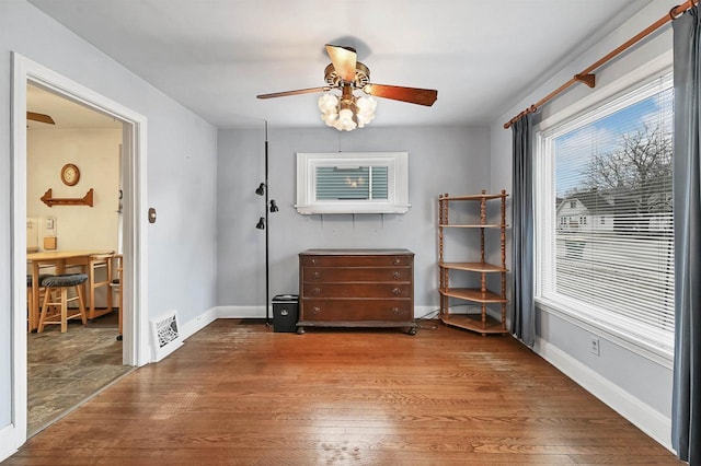 interior space featuring wood-type flooring and ceiling fan