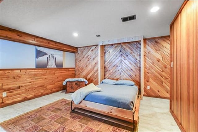 bedroom with wood walls