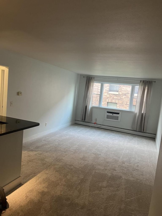 unfurnished living room featuring light colored carpet and a wall mounted AC