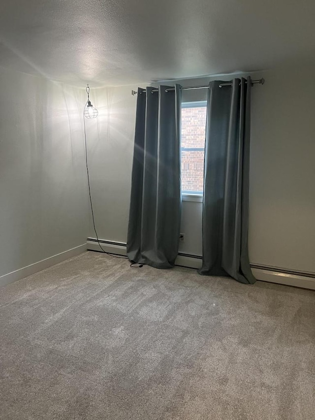 spare room with light carpet and a textured ceiling