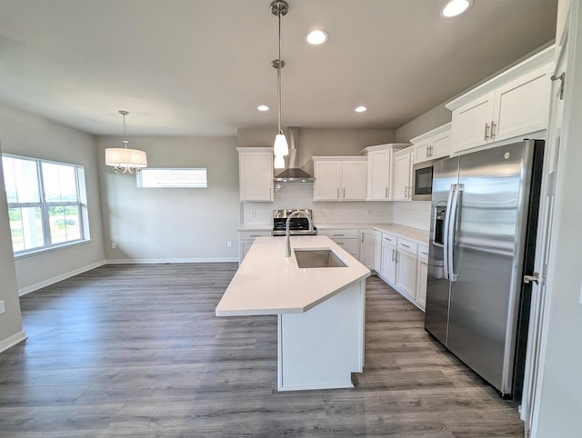 6839 Belle Fontaine Blvd, Middleton, WI 53562 - kitchen featuring appliances with stainless steel finishes, wall chimney exhaust hood, a sink, tasteful backsplash, and baseboards