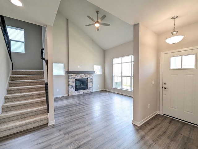 6839 Belle Fontaine Blvd, Middleton, WI 53562 - foyer entrance with healthy amount of natural light, a fireplace, wood finished floors, a ceiling fan, and high vaulted ceiling