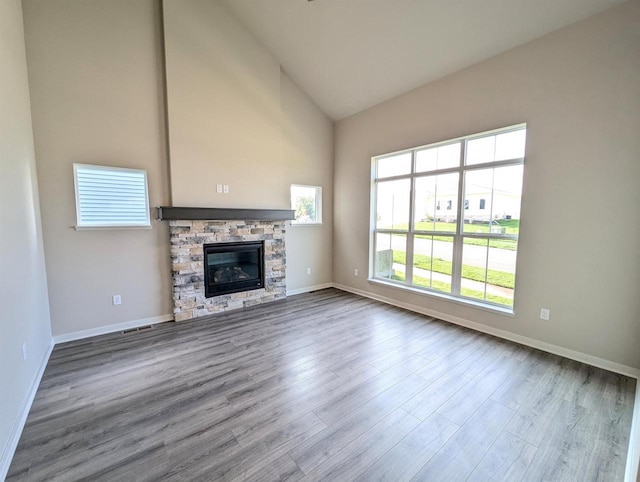 6839 Belle Fontaine Blvd, Middleton, WI 53562 - unfurnished living room with wood finished floors, high vaulted ceiling, baseboards, and a fireplace