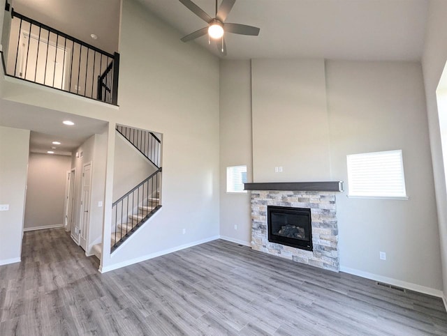 6839 Belle Fontaine Blvd, Middleton, WI 53562 - unfurnished living room with stairway, high vaulted ceiling, a ceiling fan, wood finished floors, and baseboards