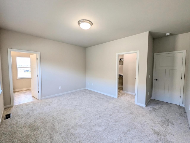 6839 Belle Fontaine Blvd, Middleton, WI 53562 - unfurnished bedroom featuring carpet, a walk in closet, a closet, and baseboards