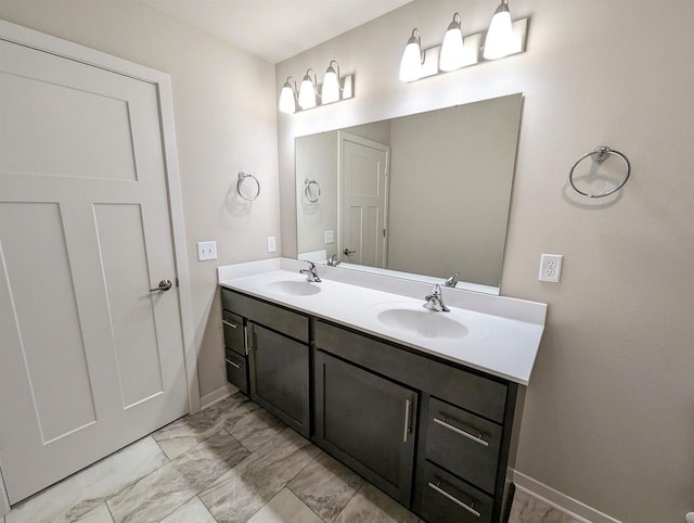 6839 Belle Fontaine Blvd, Middleton, WI 53562 - bathroom with double vanity, baseboards, and marble finish flooring