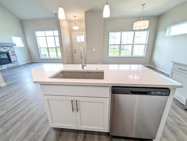 6839 Belle Fontaine Blvd, Middleton, WI 53562 - kitchen featuring dishwasher, a sink, light wood-type flooring, and white cabinets