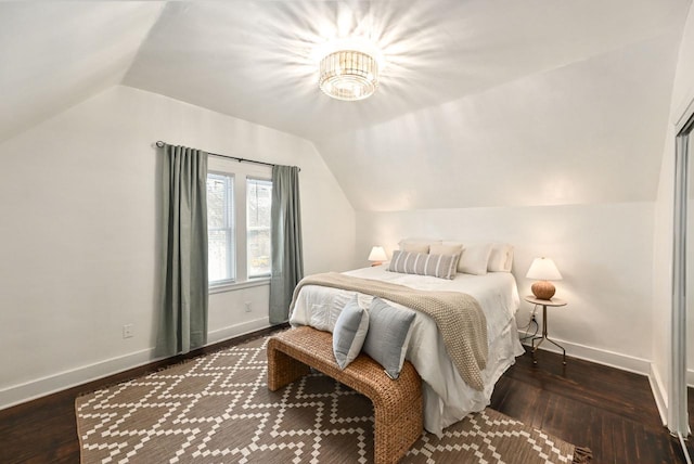 bedroom featuring lofted ceiling and dark hardwood / wood-style floors