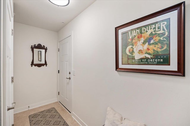 entryway featuring light colored carpet