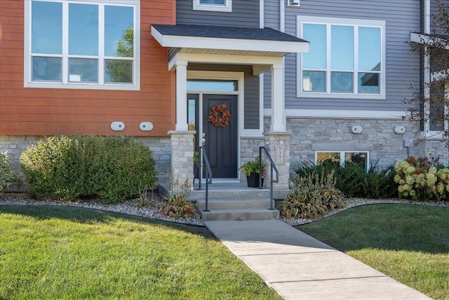 property entrance with a lawn