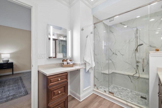 bathroom featuring ornamental molding, vanity, an enclosed shower, and wood-type flooring