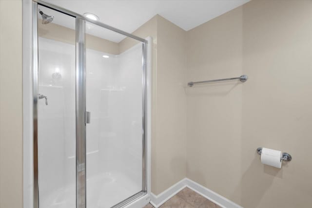 bathroom featuring tile patterned floors and a shower with door